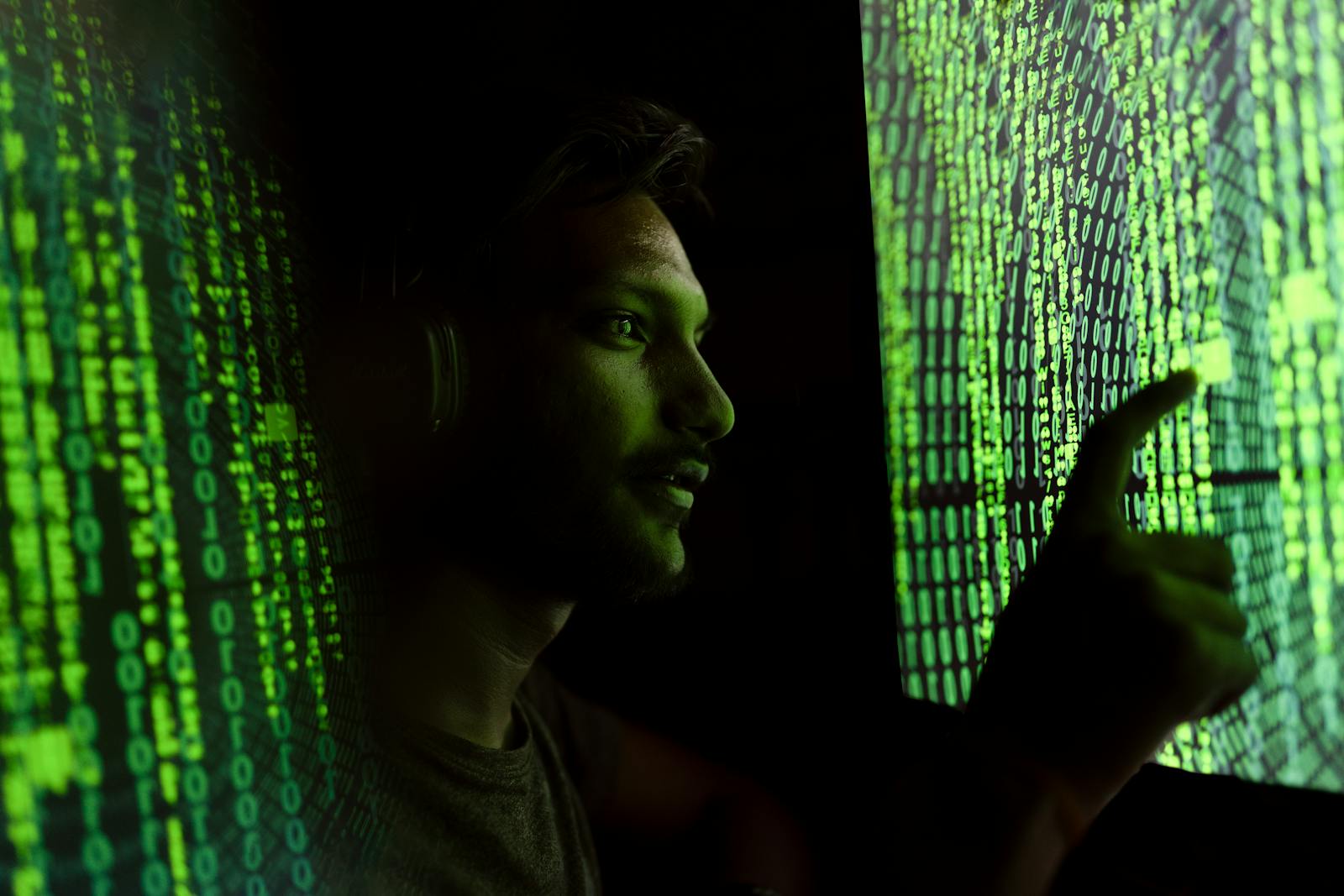A security professional reviewing digital data on large illuminated screens.